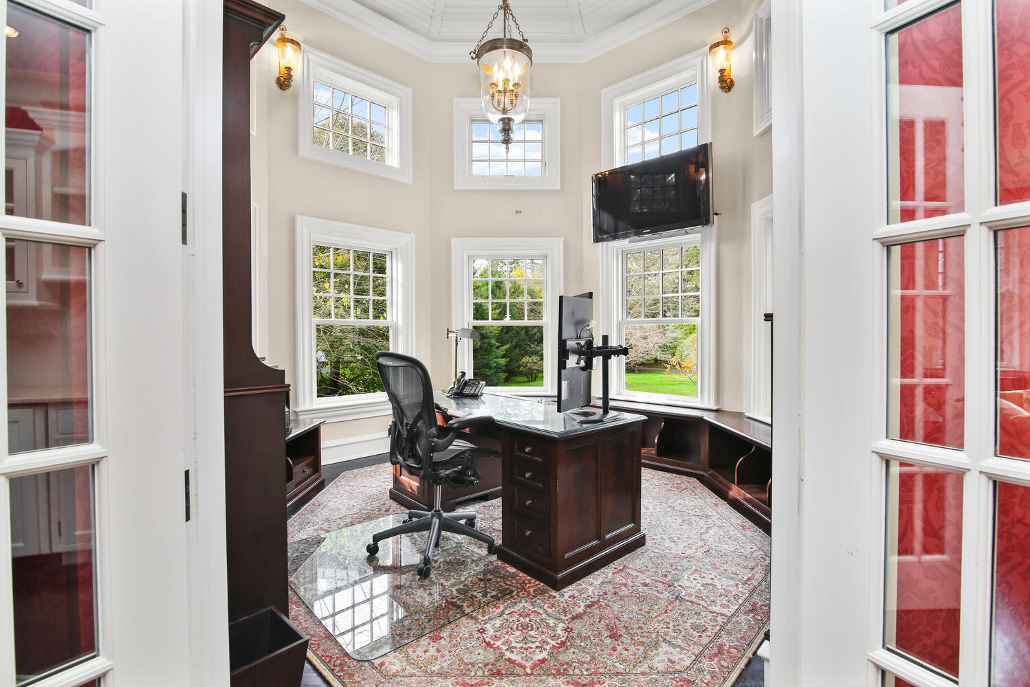 363 West Road New Canaan, CT 06840 - Photo 27 of 68 a living room with furniture a flat screen tv and floor to ceiling windows