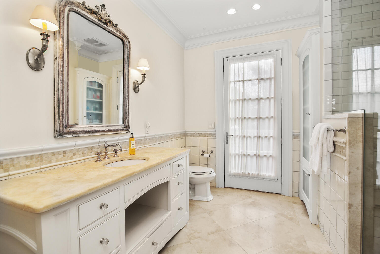 363 West Road New Canaan, CT 06840 - Photo 30 of 68 a bathroom with a double vanity sink mirror and next to a window