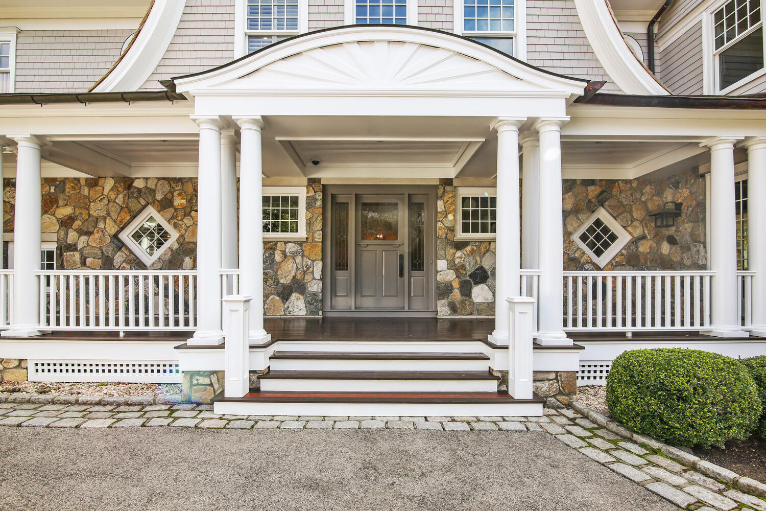 363 West Road New Canaan, CT 06840 - Photo 4 of 68 a front view of a house with a garden and plants