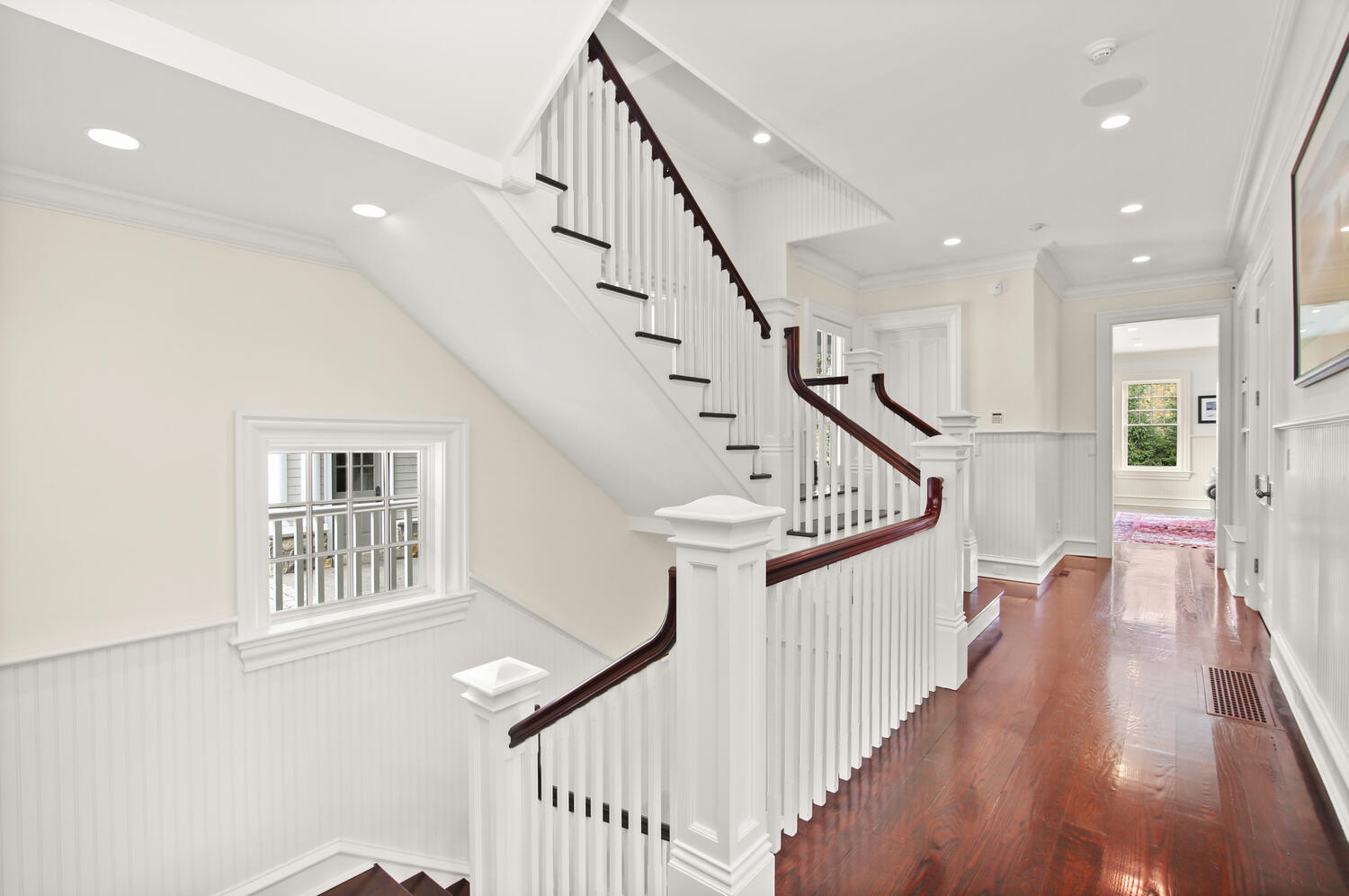 363 West Road New Canaan, CT 06840 - Photo 40 of 68 a view of staircase with lots of frames on wall and wooden floor