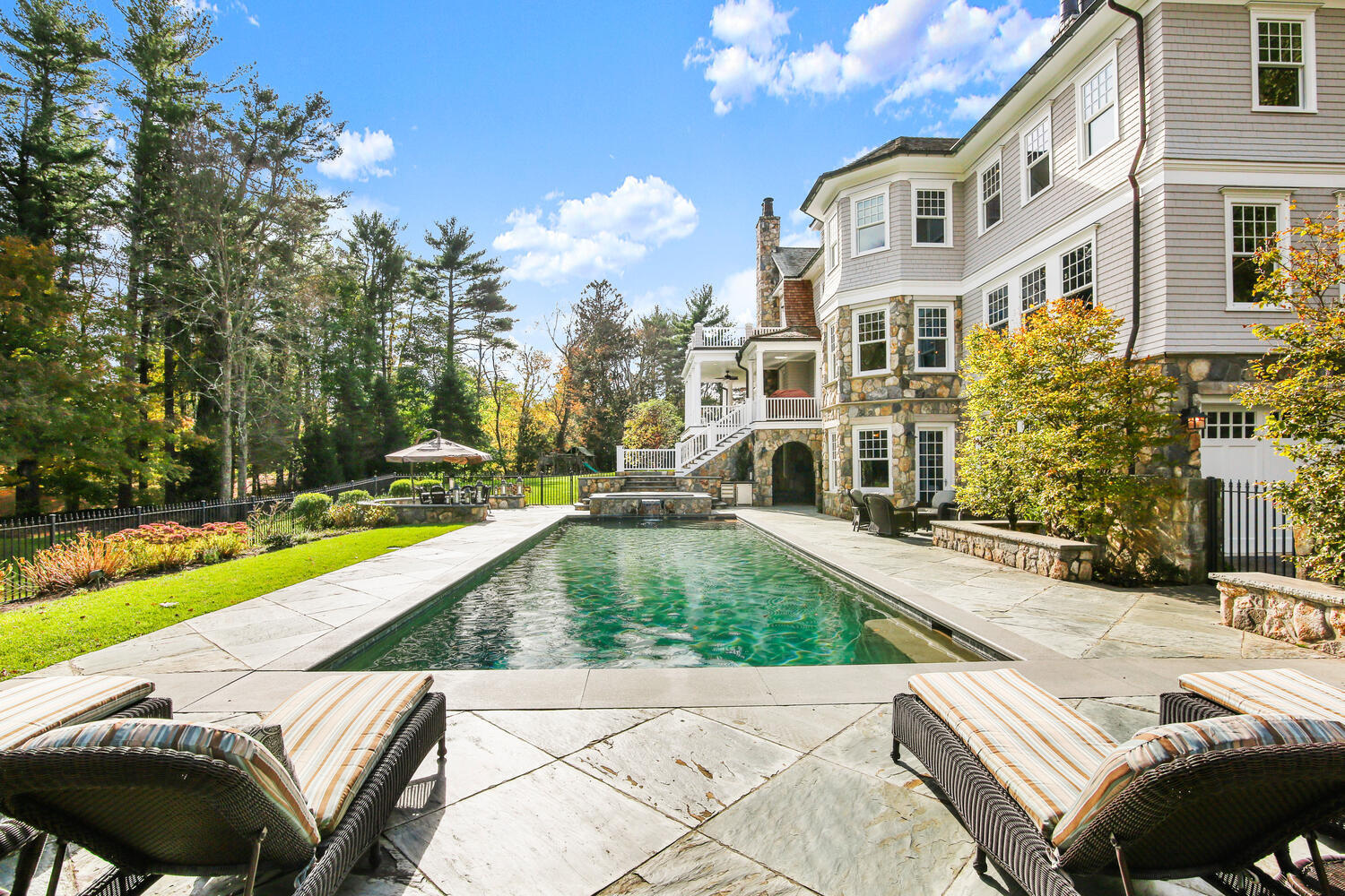 363 West Road New Canaan, CT 06840 - Photo 44 of 68 a view of a house with swimming pool and sitting area