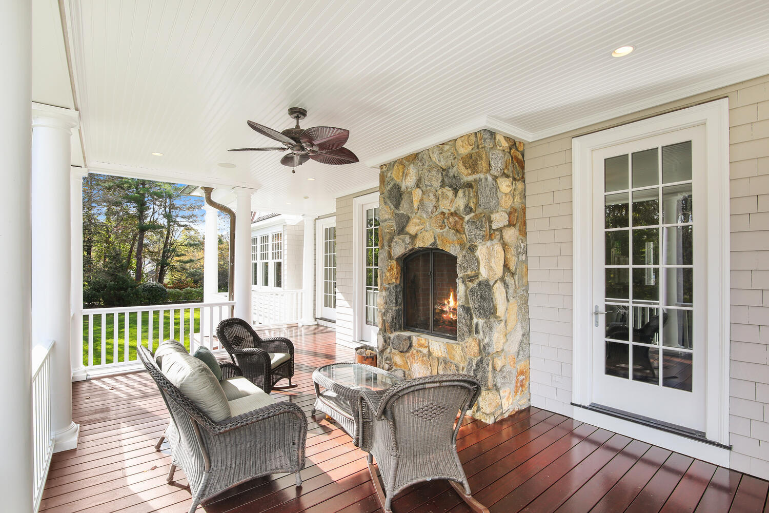 363 West Road New Canaan, CT 06840 - Photo 45 of 68 a living room with furniture a fireplace and a floor to ceiling window
