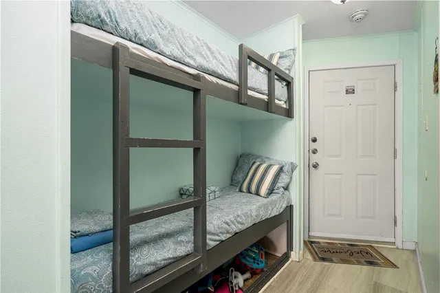 a view of a hallway with a front door and bedroom