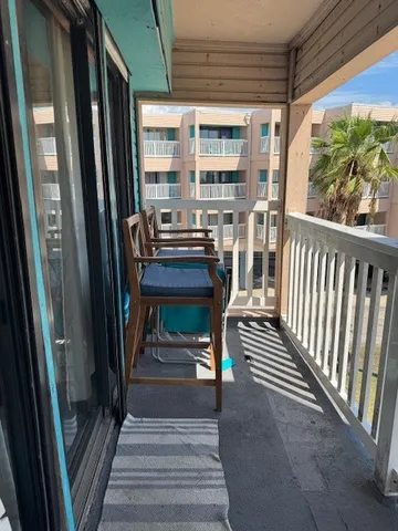 a view of a balcony with chairs