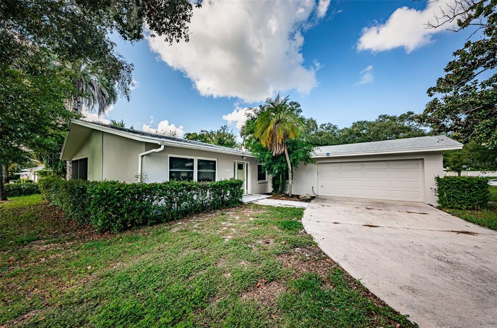 1001 Chinaberry Road Clearwater, FL 33764 - Photo 1 of 1 a front view of a house with garden