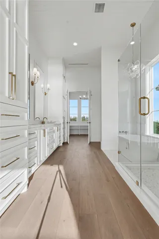 a view of a hallway with closet and cabinet