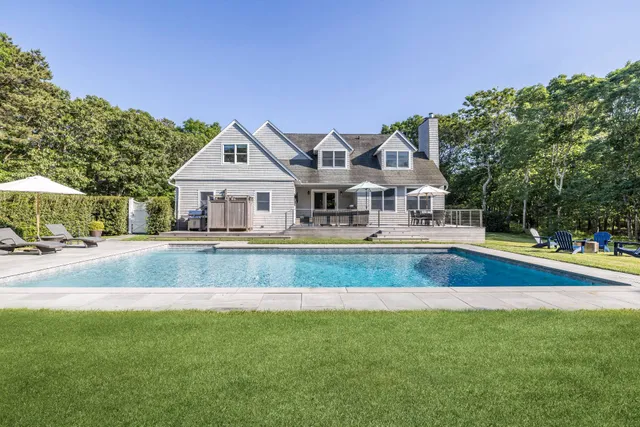 a front view of a house with a yard table and chairs