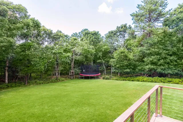 a view of a chair and tables in the backyard