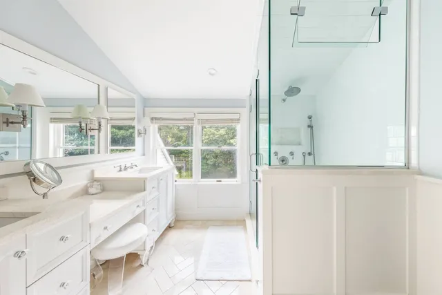 a bathroom with a tub sink and mirror