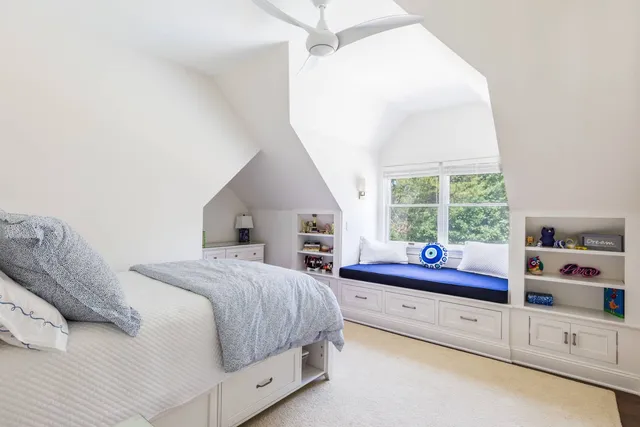 a spacious bedroom with a bed and a window