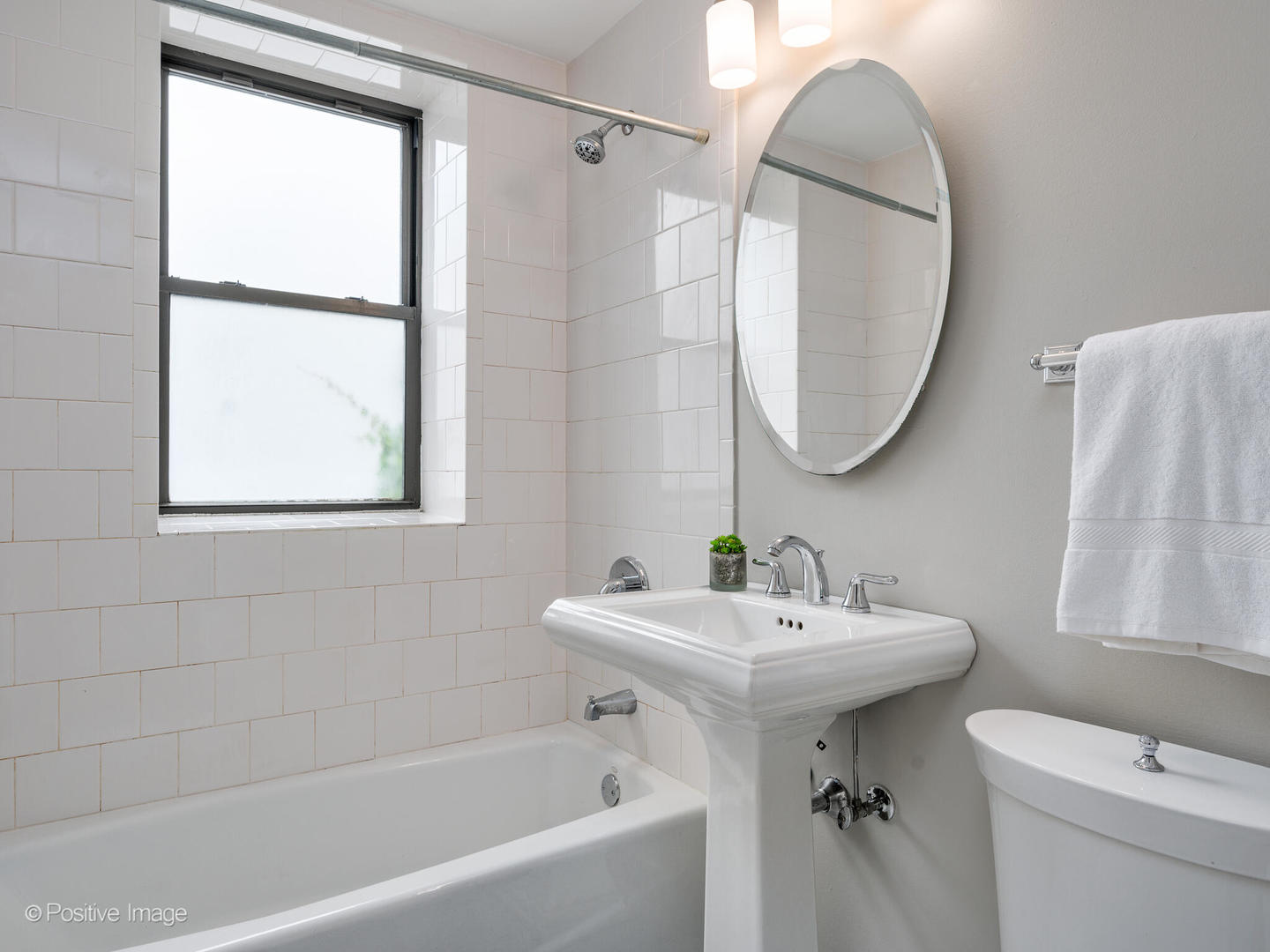 4144 North Sheridan Road, Unit 203 Chicago, IL 60613 - Photo 12 of 15 a bathroom with a sink toilet and a mirror