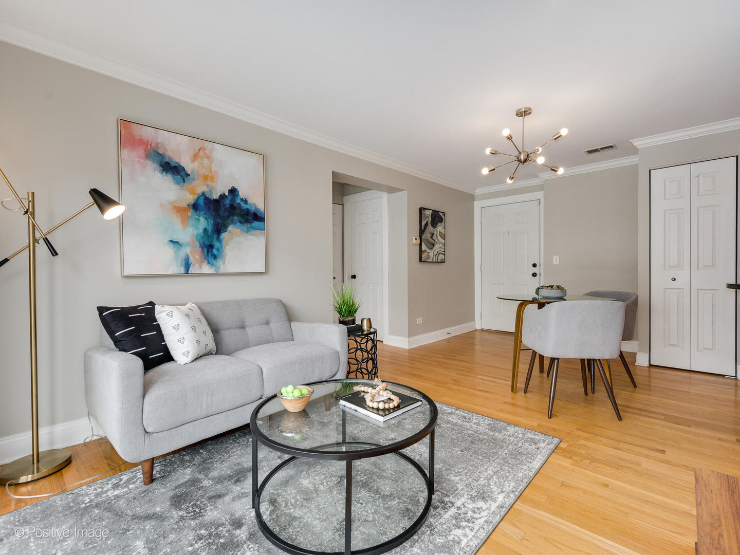 4144 North Sheridan Road, Unit 203 Chicago, IL 60613 - Photo 4 of 15 a living room with furniture and a chandelier