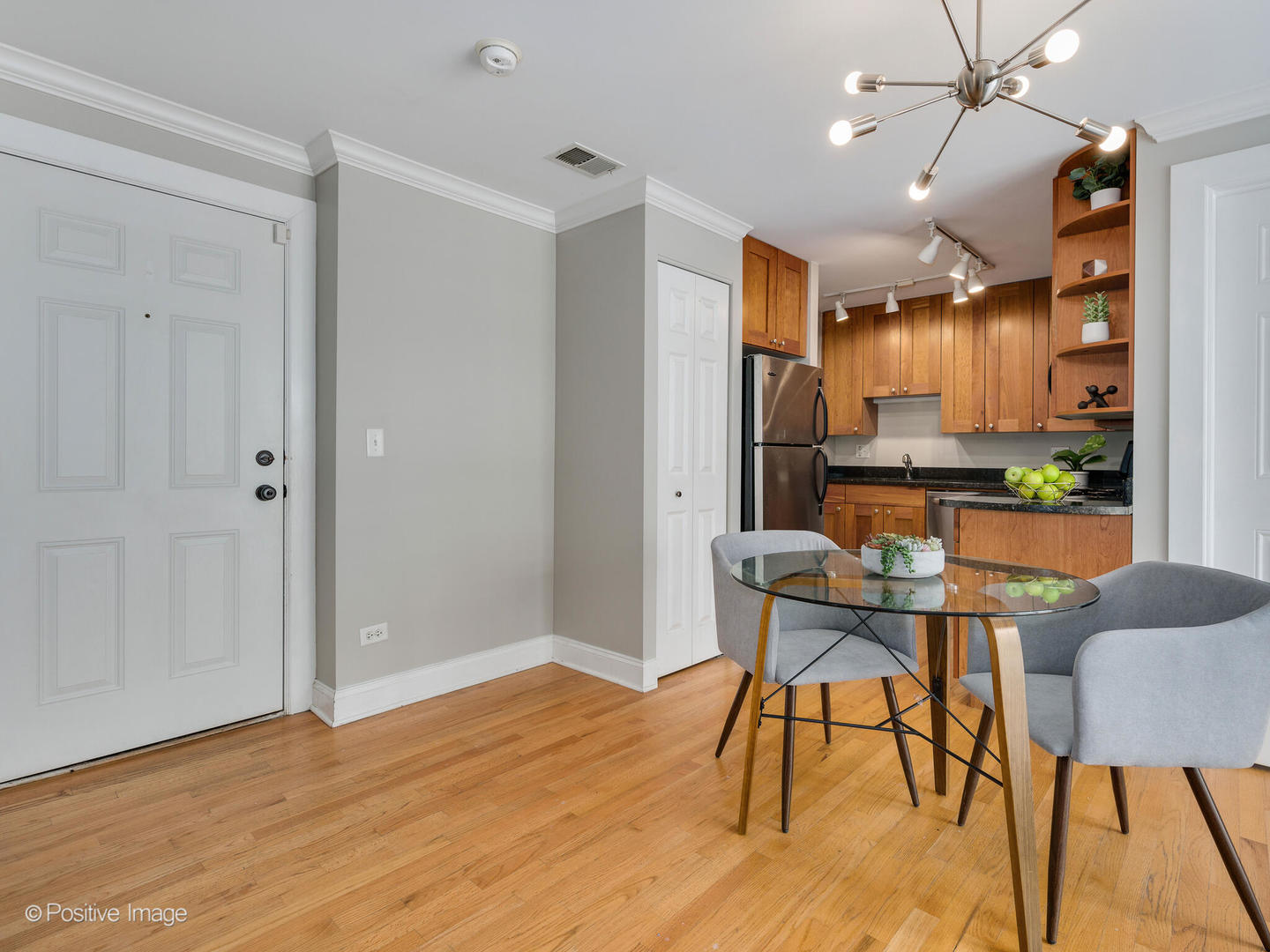 4144 North Sheridan Road, Unit 203 Chicago, IL 60613 - Photo 6 of 15 a view of a dining room with furniture and wooden floor