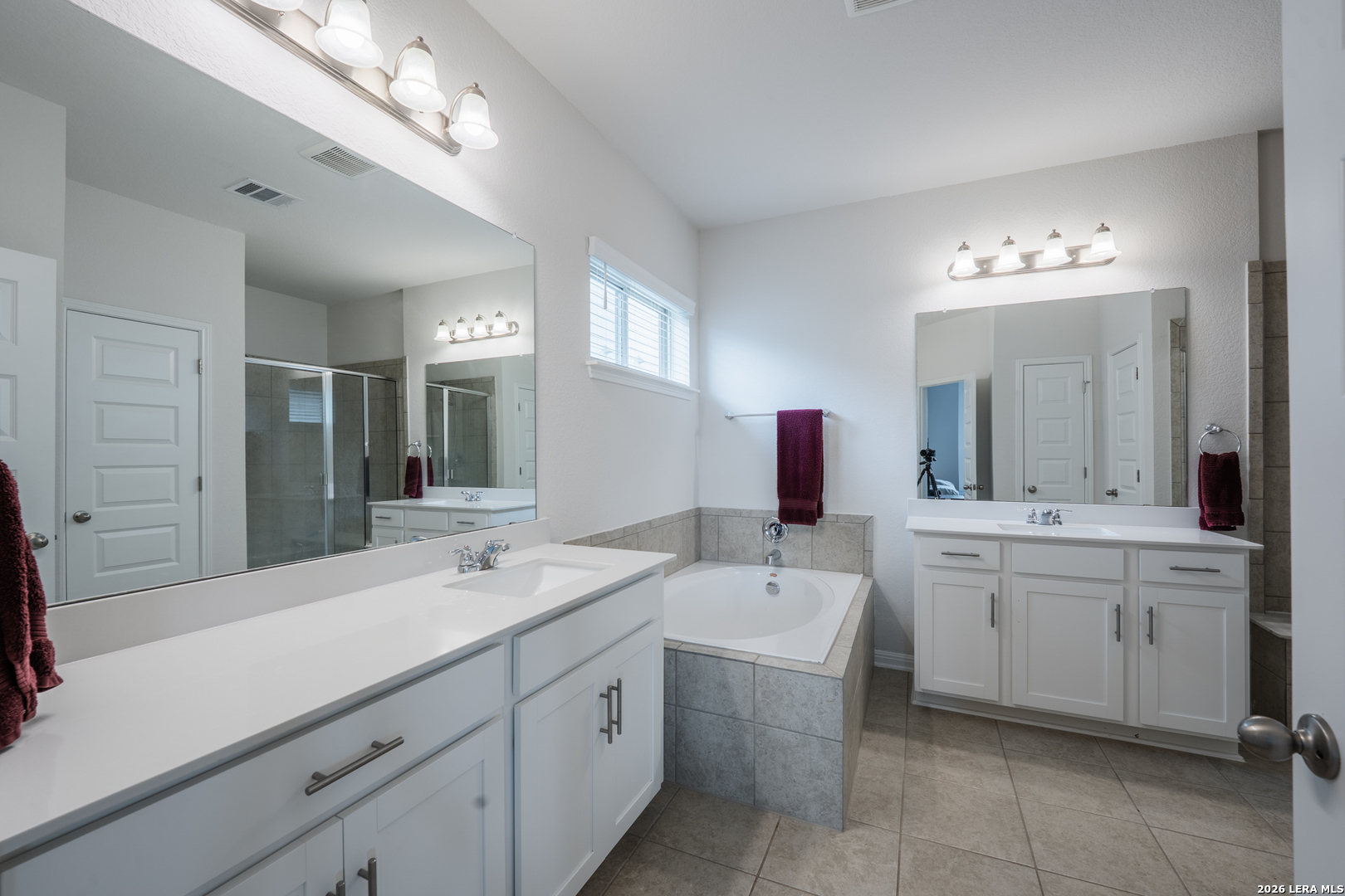 4947 Ranahan Pass St. Hedwig, TX 78152 - Photo 17 of 37 a spacious bathroom with a double vanity sink mirror and bathtub