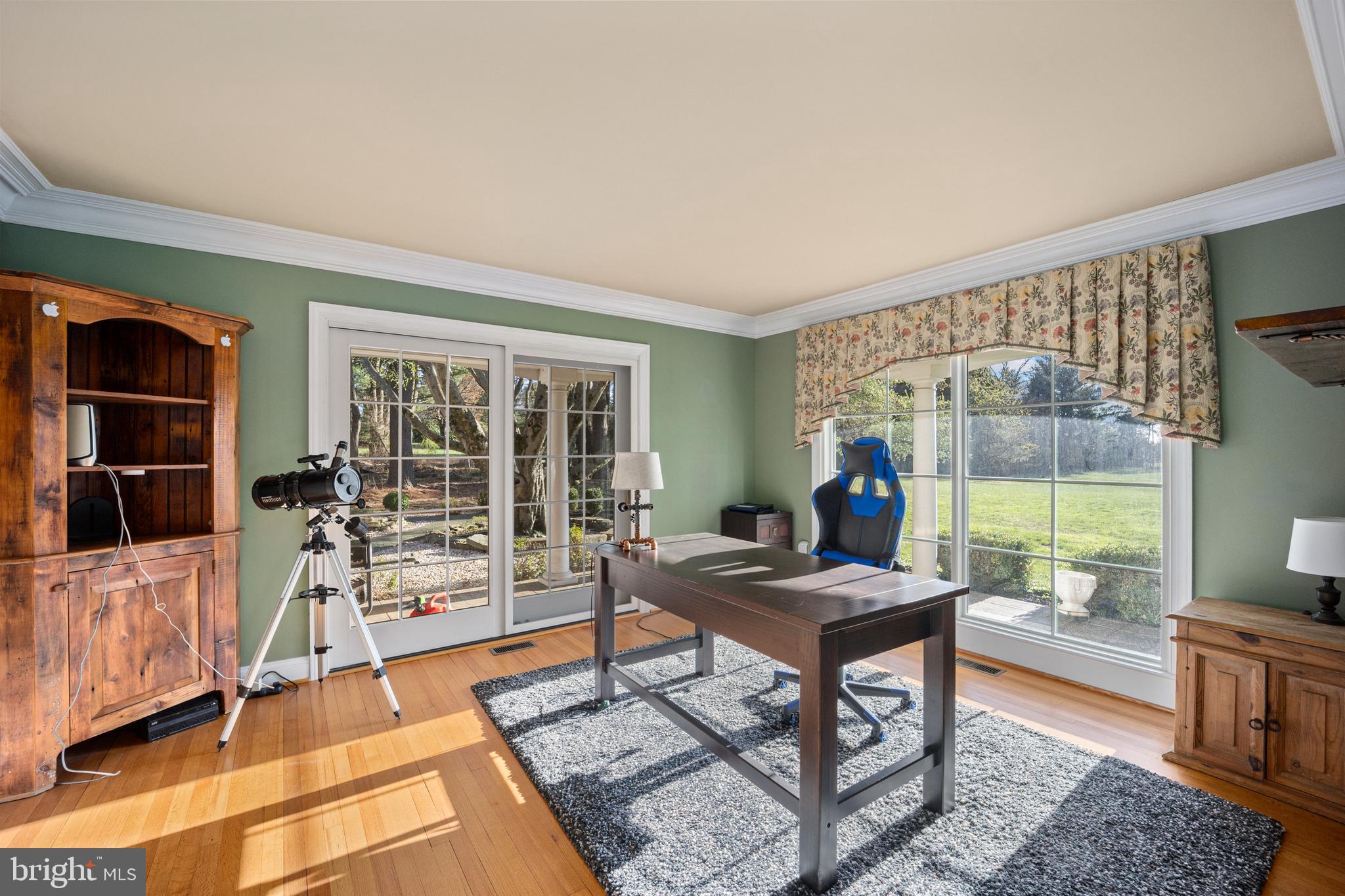 734 Northbrook Road Kennett Square, PA 19348 - Photo 40 of 89 a living room with furniture a flat screen tv and a floor to ceiling window