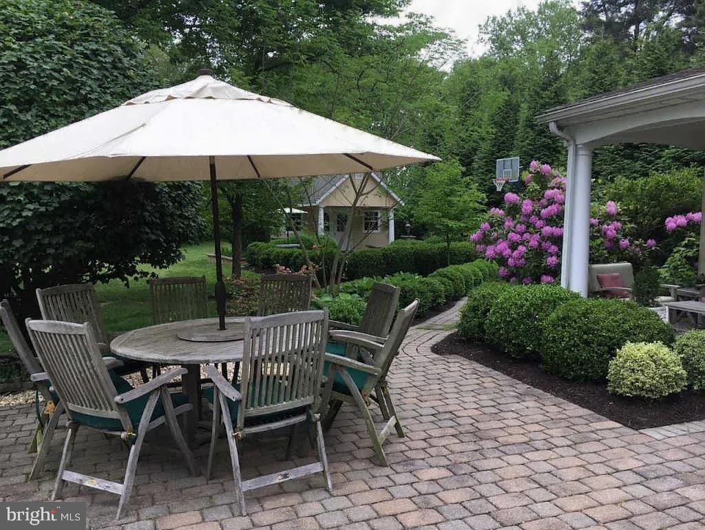734 Northbrook Road Kennett Square, PA 19348 - Photo 8 of 89 a view of a wooden table and chairs under an umbrella