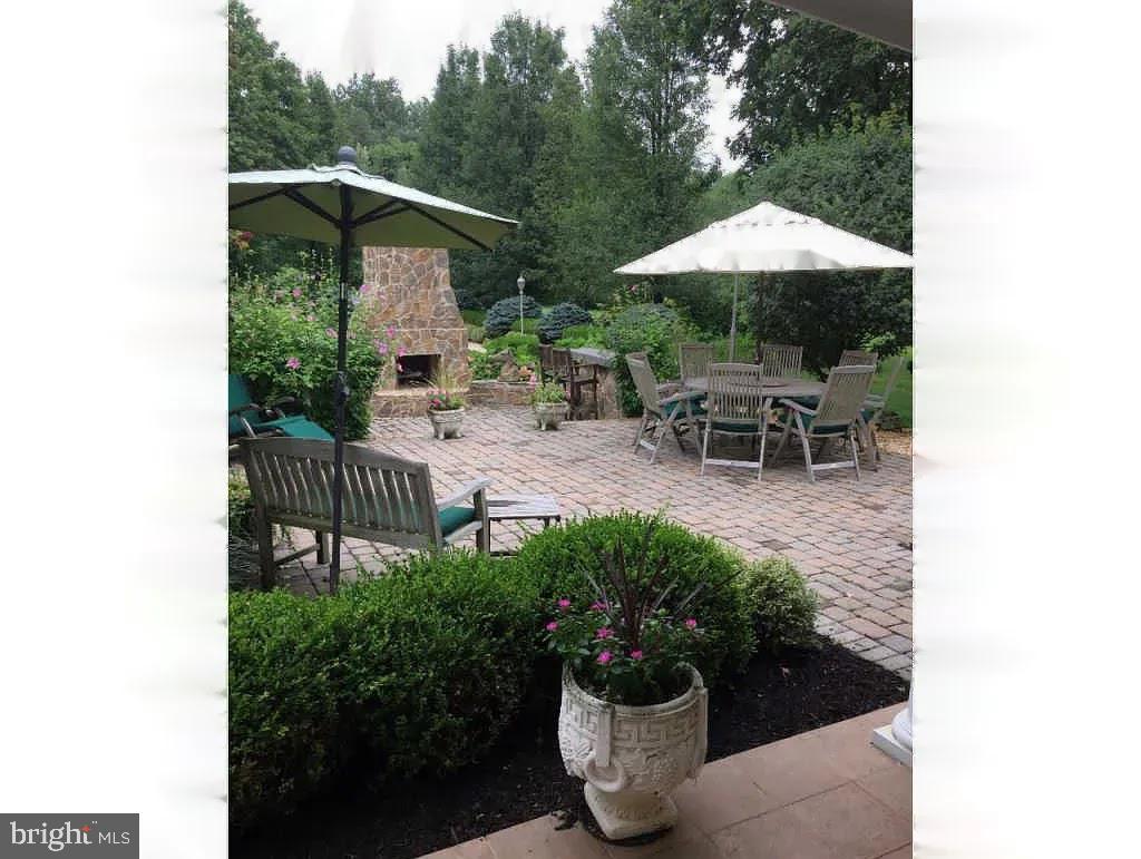 734 Northbrook Road Kennett Square, PA 19348 - Photo 9 of 89 a view of a chair and table under an umbrella in patio