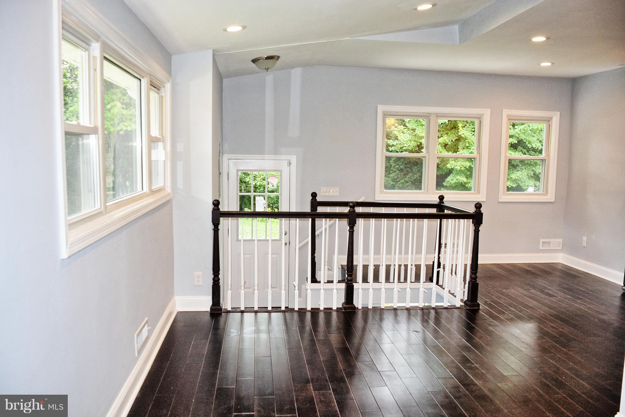 4716 Bonnie Brae Road Baltimore, MD 21208 - Photo 4 of 15 a view of wooden floor and windows in a room