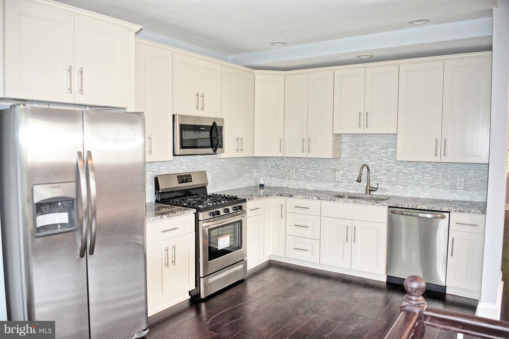 4716 Bonnie Brae Road Baltimore, MD 21208 - Photo 5 of 15 a kitchen with stainless steel appliances granite countertop a stove a sink and a refrigerator