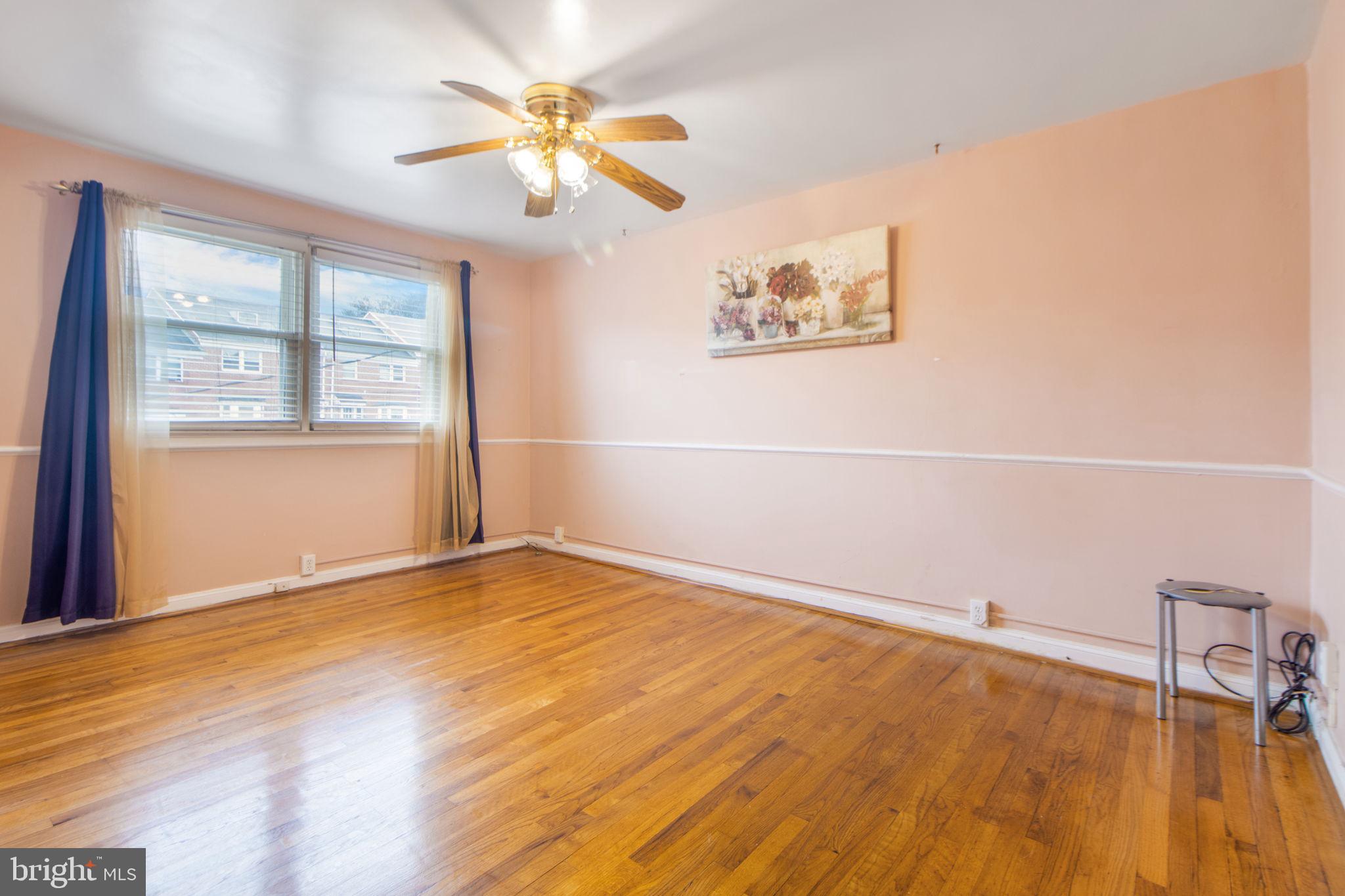 1903 Heathfield Road Baltimore, MD 21239 - Photo 12 of 30 a view of an empty room with a window and wooden floor