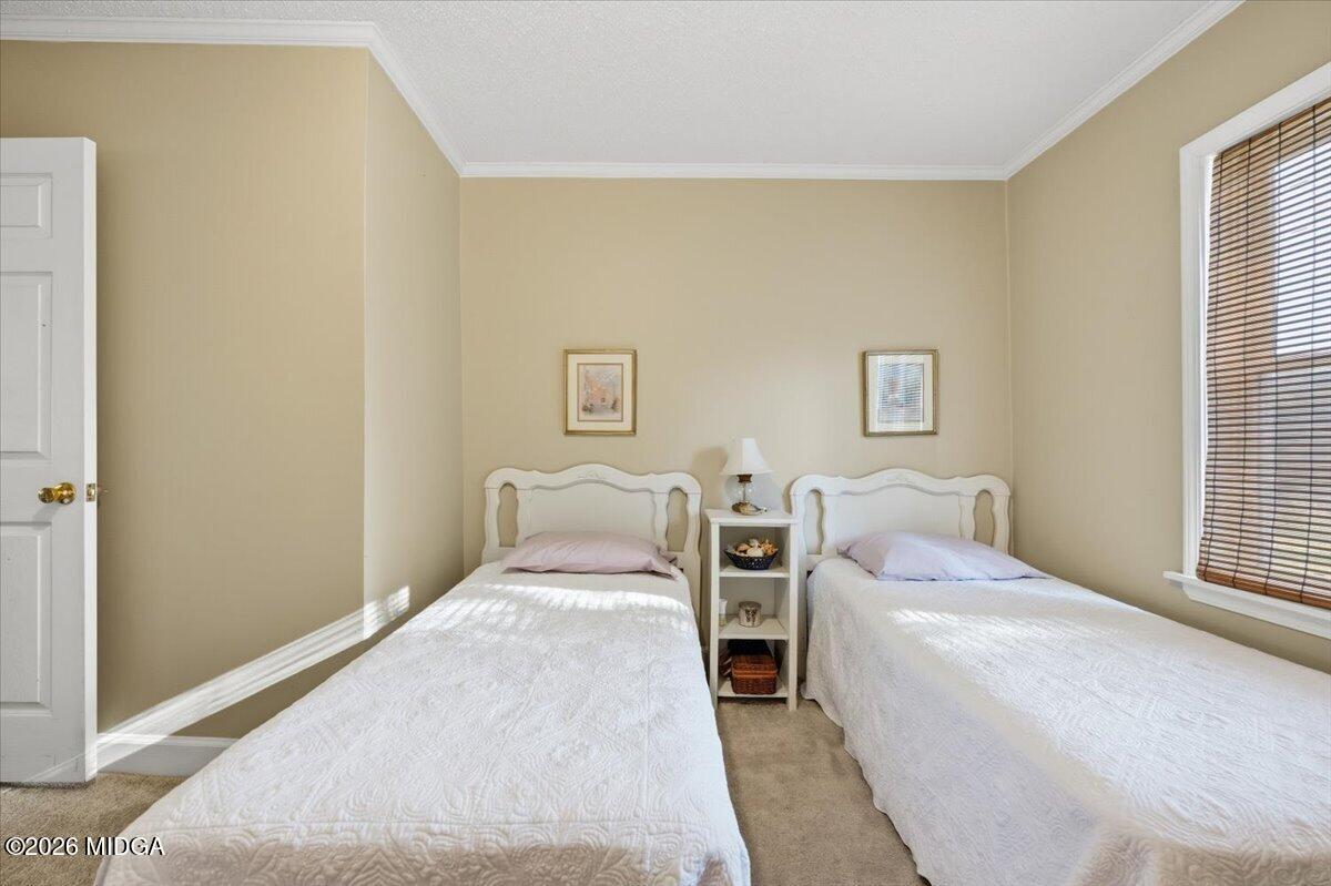 214 Howard Roberts Road Gray, GA 31032 - Photo 20 of 36 a bedroom with a bed and a night stand