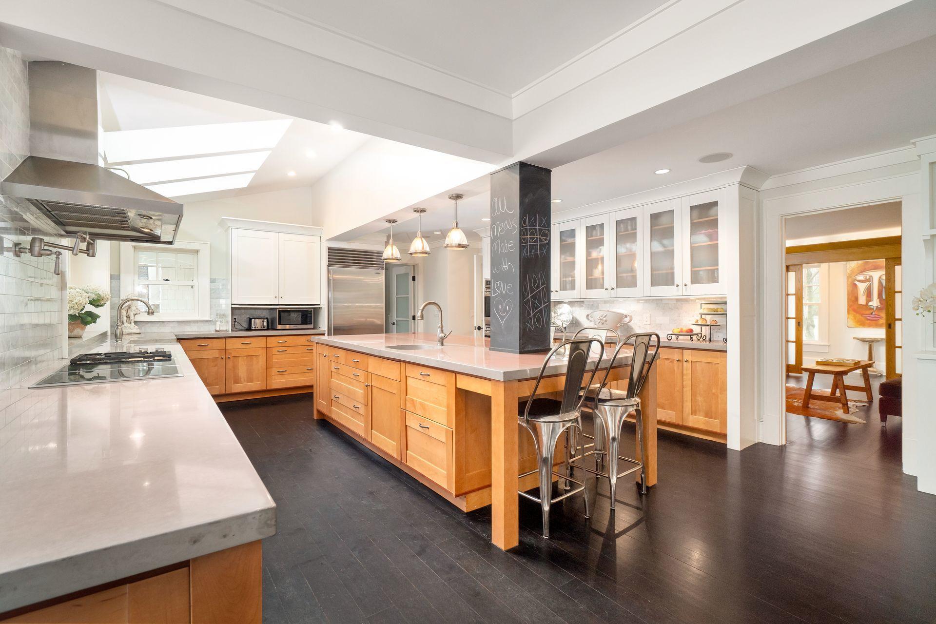 57 Rilling Ridge New Canaan, CT 06840 - Photo 14 of 68 a large white kitchen with wooden floor and a sink