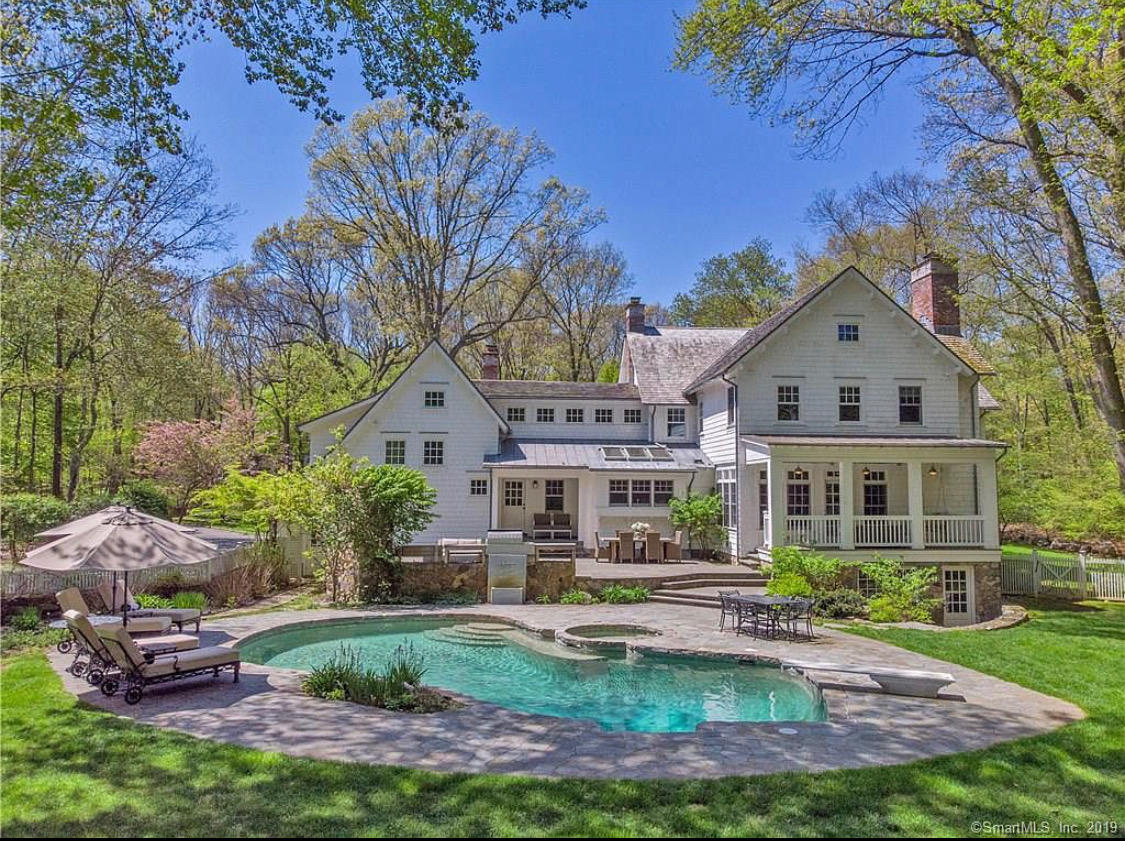 57 Rilling Ridge New Canaan, CT 06840 - Photo 2 of 68 a front view of a house with a garden and plants