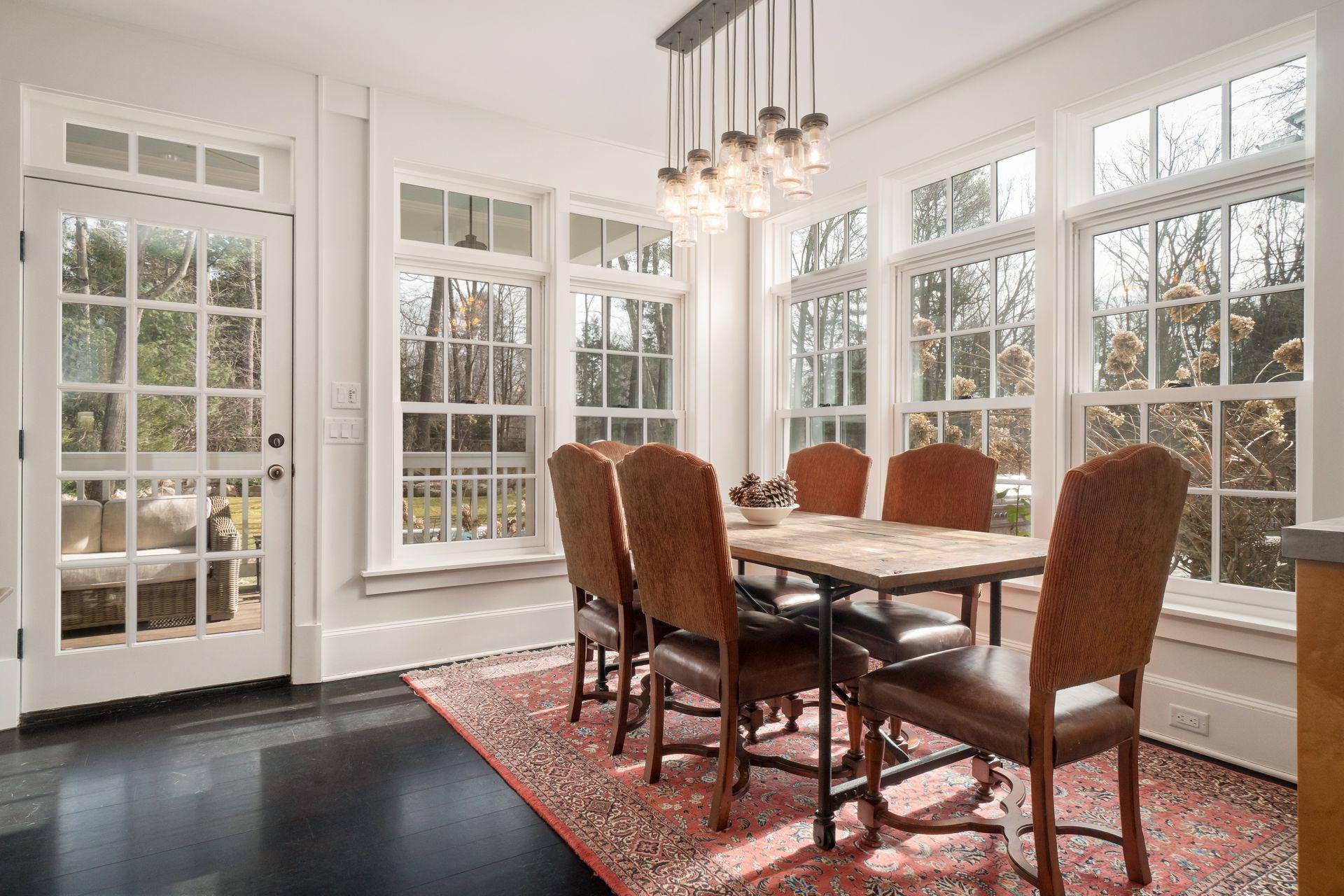 57 Rilling Ridge New Canaan, CT 06840 - Photo 21 of 68 a view of a dining room with furniture a chandelier and wooden floor