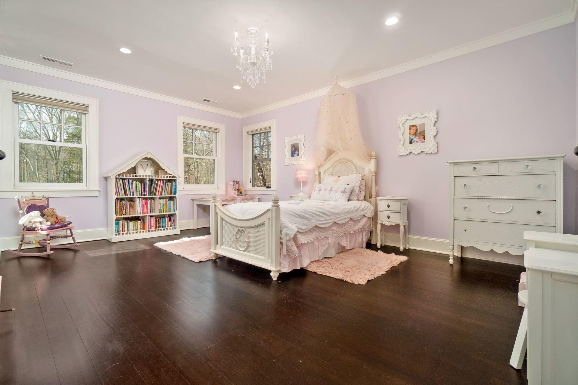 57 Rilling Ridge New Canaan, CT 06840 - Photo 35 of 68 a spacious bedroom with a bed and wooden floor