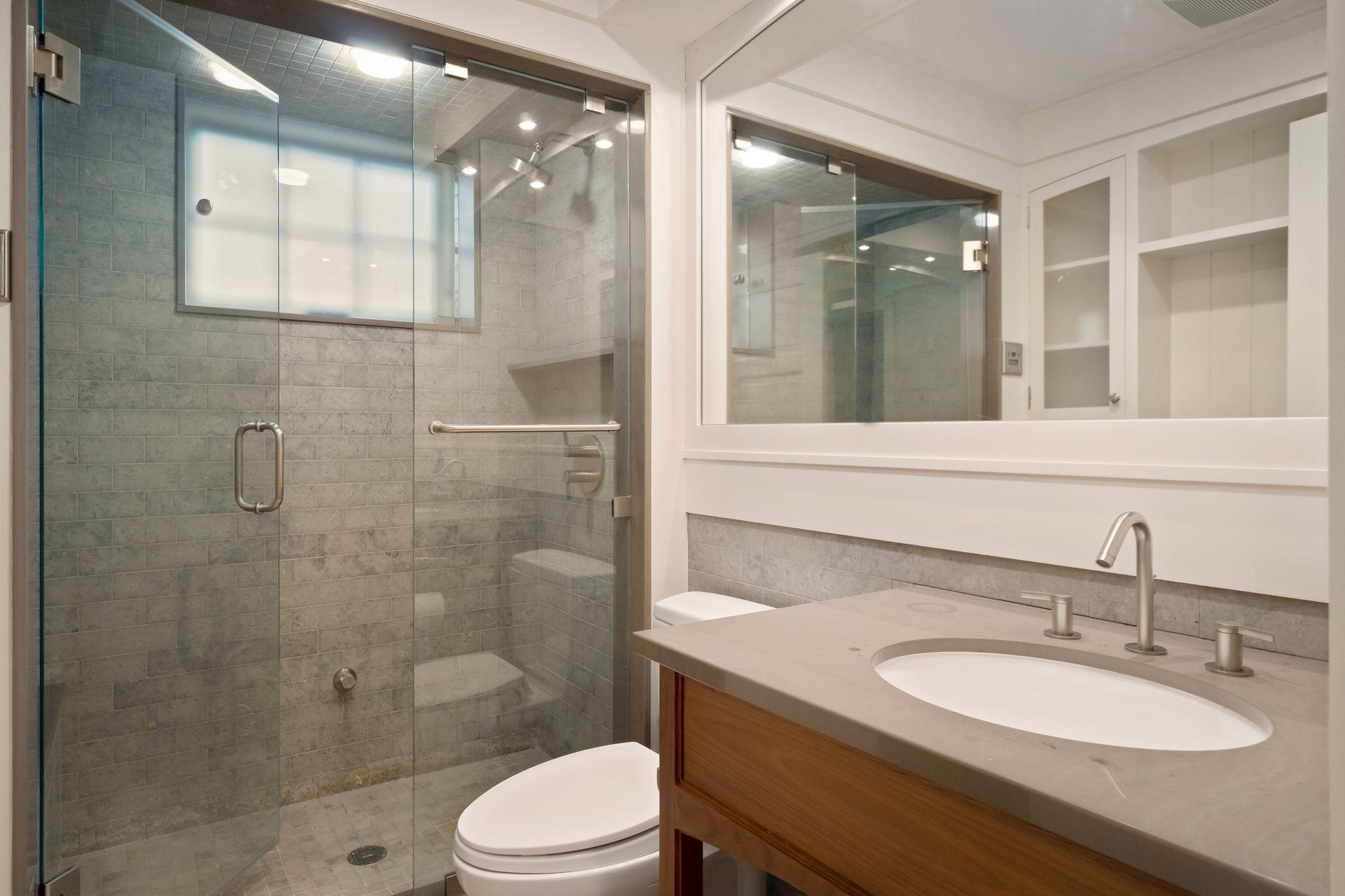 57 Rilling Ridge New Canaan, CT 06840 - Photo 51 of 68 a bathroom with a granite countertop sink toilet a mirror and shower