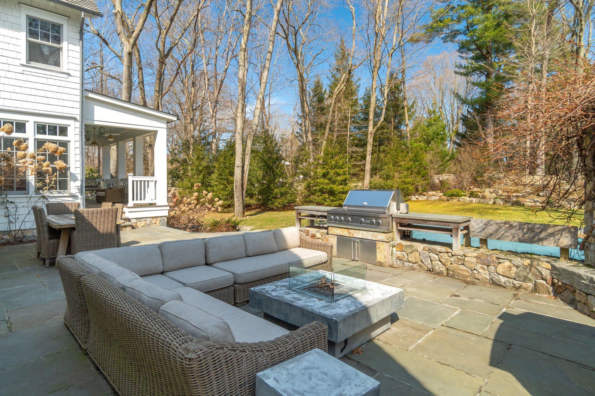 57 Rilling Ridge New Canaan, CT 06840 - Photo 62 of 68 a view of a patio with couches and a potted plant on a table