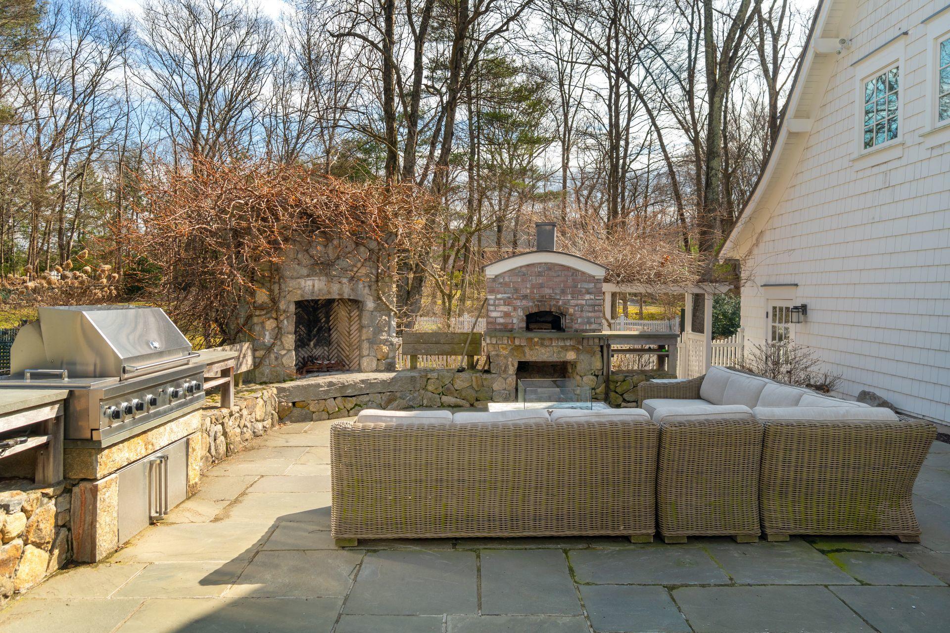 57 Rilling Ridge New Canaan, CT 06840 - Photo 63 of 68 a view of a patio with couches fire pit and a barbeque