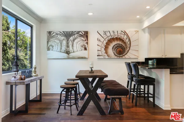 a view of a dining area with furniture and wooden floor