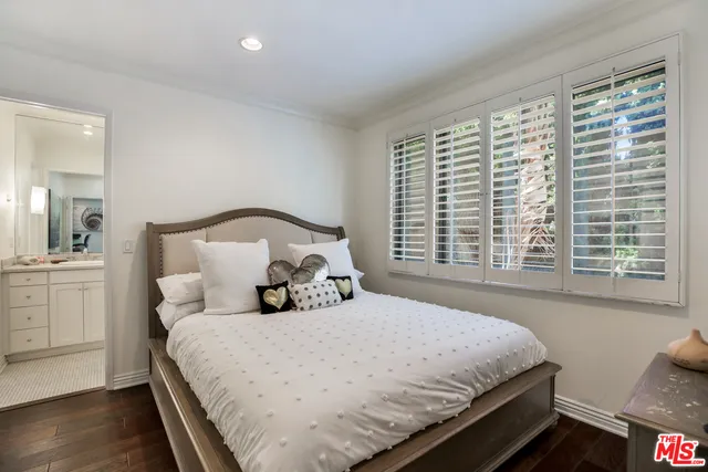 a bedroom with a large bed and a large window