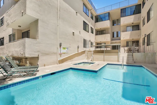 a view of a kitchen with granite countertop a sink and a stove