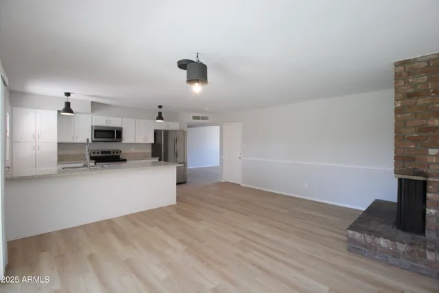a view of kitchen with furniture and wooden floor