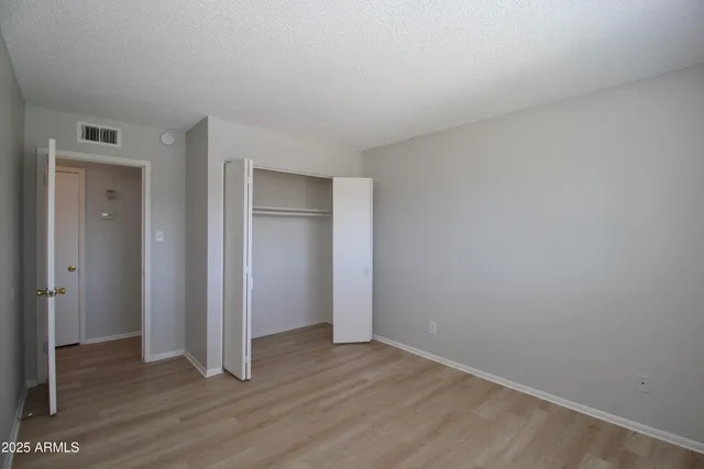 a view of an empty room and wooden floor