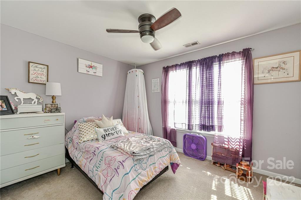122 Chimney Rock Lane Fort Mill, SC 29708 - Photo 18 of 27 a bedroom with a bed a dresser and a window