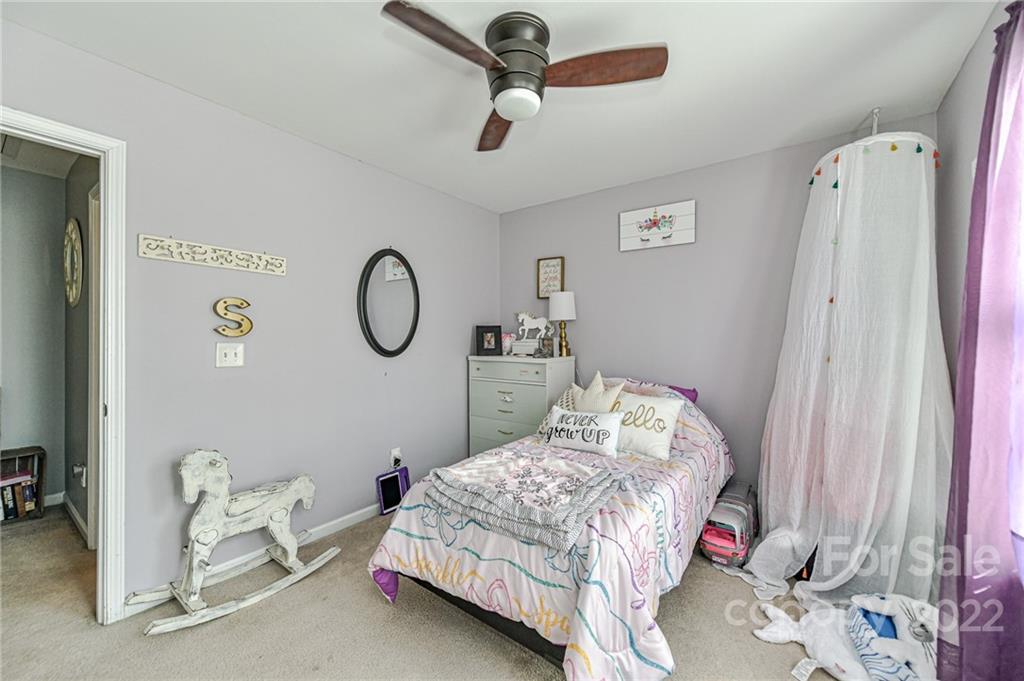 122 Chimney Rock Lane Fort Mill, SC 29708 - Photo 19 of 27 a bedroom with a bed and a mirror