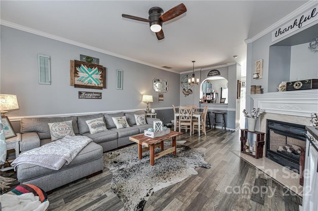 122 Chimney Rock Lane Fort Mill, SC 29708 - Photo 5 of 27 a living room with furniture a fireplace and a chandelier