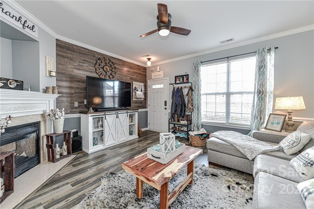 122 Chimney Rock Lane Fort Mill, SC 29708 - Photo 6 of 27 a living room with furniture a flat screen tv and a fireplace