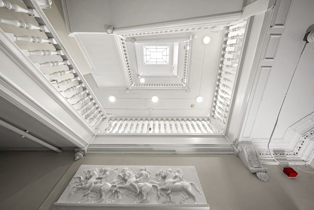 a view of staircase with white walls and a window