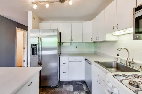 a kitchen with a sink stove and refrigerator