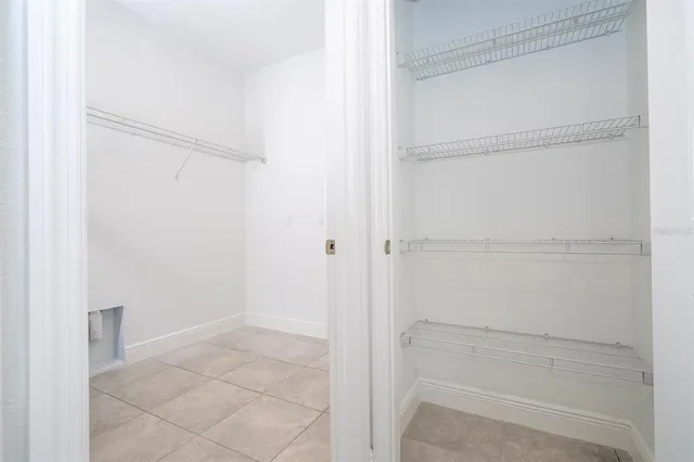 a view of an empty room with a white cabinet
