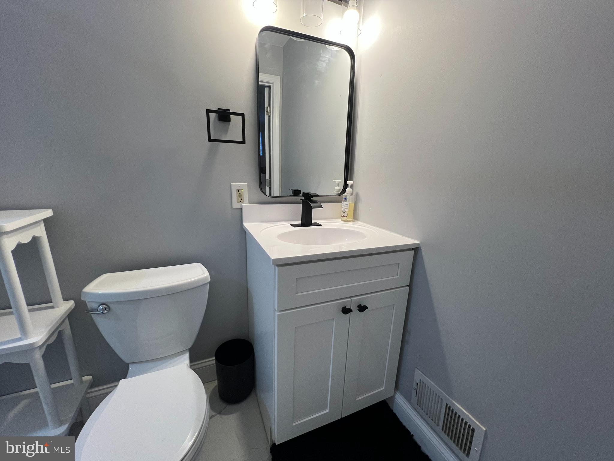 401 Imla Street Baltimore, MD 21224 - Photo 23 of 28 a bathroom with a toilet sink and mirror
