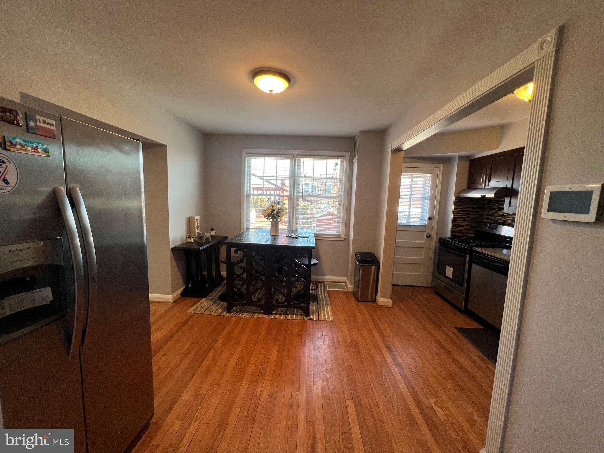 401 Imla Street Baltimore, MD 21224 - Photo 10 of 28 a kitchen with sink refrigerator and wooden floor