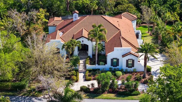 a view of a house with a yard and garden