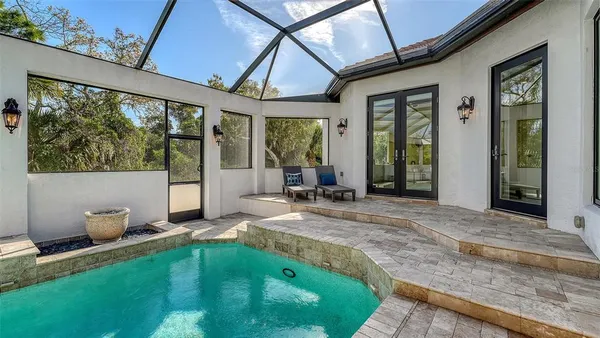 an aerial view of a house with outdoor space and lake view