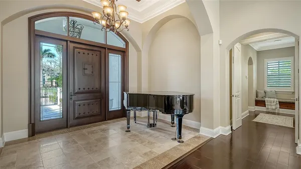 a living room with fireplace furniture and a chandelier