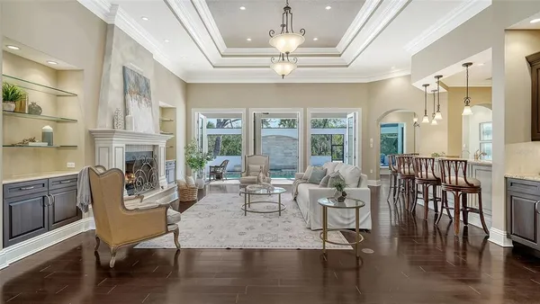 a living room with furniture and a open kitchen view